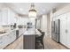 Bright kitchen with stainless steel appliances, modern lighting, and a spacious center island with seating at 10478 E Sheena Dr, Scottsdale, AZ 85255