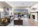 Comfortable living room with a fireplace, a sliding glass door to backyard and a contemporary design at 10478 E Sheena Dr, Scottsdale, AZ 85255