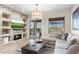 Relaxing living room with fireplace, comfortable seating, and a seamless transition to outdoor living space at 10478 E Sheena Dr, Scottsdale, AZ 85255