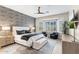 Inviting main bedroom with a king bed, accent wall, ceiling fan, and bright bay window seating area at 10478 E Sheena Dr, Scottsdale, AZ 85255