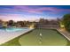 Backyard features a putting green, pool, desert landscaping, and views of the desert mountains at 10478 E Sheena Dr, Scottsdale, AZ 85255