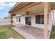 Backyard featuring green turf, rock landscaping, and a covered patio with ceiling fan at 1061 E Linda Ln, Gilbert, AZ 85234