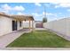 Backyard featuring green grass, rock landscaping, and covered patio with ceiling fan at 1061 E Linda Ln, Gilbert, AZ 85234