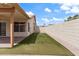 Backyard featuring green grass, rock landscaping, and a covered patio with ceiling fan at 1061 E Linda Ln, Gilbert, AZ 85234