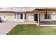 Backyard featuring artificial grass, stone, and covered patio with ceiling fan at 1061 E Linda Ln, Gilbert, AZ 85234