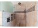 Bathroom shower featuring tiled walls, a rainfall shower head, and built-in shelves at 1061 E Linda Ln, Gilbert, AZ 85234