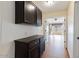 Hallway featuring wood-look tile flooring and a built-in dark wood storage cabinet at 1061 E Linda Ln, Gilbert, AZ 85234