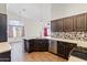 Modern kitchen featuring dark wood cabinets, stainless steel appliances, and mosaic tile backsplash at 1061 E Linda Ln, Gilbert, AZ 85234