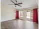 Spacious living room featuring wood floors, a ceiling fan, and access to the outdoor living area at 1061 E Linda Ln, Gilbert, AZ 85234