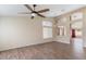 Spacious living room features wood-look tile flooring, a ceiling fan, and an open layout at 1061 E Linda Ln, Gilbert, AZ 85234