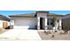 Charming single-story home featuring a two-car garage and desert landscaping for a modern look at 10612 W Sonrisas St, Tolleson, AZ 85353