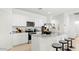 Bright, white kitchen featuring an island with barstool seating, granite countertops and stainless steel appliances at 10612 W Sonrisas St, Tolleson, AZ 85353