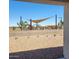 View from the home includes a shaded playground with desert landscaping at 10612 W Sonrisas St, Tolleson, AZ 85353