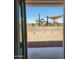 View from home of shaded playground, safety fence, and desert landscaping at 10612 W Sonrisas St, Tolleson, AZ 85353