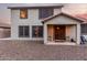 Covered patio with chairs in a large backyard with desert landscaping at 12300 N 142Nd Ln, Surprise, AZ 85379