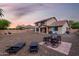 Large backyard with patio furniture, lounge chairs and desert landscaping at 12300 N 142Nd Ln, Surprise, AZ 85379