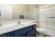 Bathroom featuring a wide mirror and a shower and bath combo at 12300 N 142Nd Ln, Surprise, AZ 85379