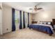 This spacious carpeted bedroom has a ceiling fan, large windows, and an inviting atmosphere at 12300 N 142Nd Ln, Surprise, AZ 85379
