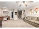 A large versatile bonus room with neutral carpet, ceiling fan, couch and desk at 12300 N 142Nd Ln, Surprise, AZ 85379