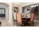 Elegant dining room showcasing a stylish chandelier, staircase, and seamless flow into the kitchen at 12300 N 142Nd Ln, Surprise, AZ 85379