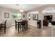 This dining area features sleek wood floors, a modern light fixture, and sliding glass doors to let in natural light at 12300 N 142Nd Ln, Surprise, AZ 85379