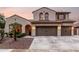 Charming two-story home featuring a three car garage, desert landscaping, and a red tile roof at 12300 N 142Nd Ln, Surprise, AZ 85379