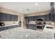 Spacious kitchen with an island, stainless steel appliances, granite countertops, and ample cabinet space at 12300 N 142Nd Ln, Surprise, AZ 85379