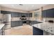 Modern kitchen featuring gray cabinets, stainless steel appliances, granite countertops, and a bright window at 12300 N 142Nd Ln, Surprise, AZ 85379