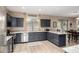 Stylish kitchen featuring granite countertops, stainless appliances, gray cabinets and an adjacent dining area at 12300 N 142Nd Ln, Surprise, AZ 85379