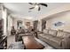 Open-concept living room featuring neutral tones, archways, and seamless flow into the dining area at 12300 N 142Nd Ln, Surprise, AZ 85379