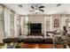 Bright living room with large windows, a ceiling fan, modern decor, and wood style flooring at 12300 N 142Nd Ln, Surprise, AZ 85379