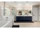 The beautiful main bathroom has double sinks, a shower, and a tub at 12300 N 142Nd Ln, Surprise, AZ 85379