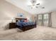 Bright main bedroom with a ceiling fan, two nightstands, and large windows at 12300 N 142Nd Ln, Surprise, AZ 85379