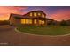 Large backyard features lush green grass, a covered patio, and desert landscaping at 12473 W Montgomery Rd, Peoria, AZ 85383