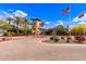 Grand entrance to the community with mature landscaping, guard house, and ample guest parking at 12473 W Montgomery Rd, Peoria, AZ 85383