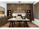 This home office features custom shelving and cabinetry, recessed lighting, and a stylish marble desk at 12473 W Montgomery Rd, Peoria, AZ 85383