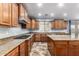 This kitchen features recessed lighting, wood cabinetry, granite countertops, and a gas cooktop at 12473 W Montgomery Rd, Peoria, AZ 85383