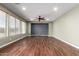 This empty living room features dark wood flooring, recessed lighting, and a ceiling fan at 12473 W Montgomery Rd, Peoria, AZ 85383