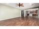This living room features wood flooring, recessed lighting, and an opening to the kitchen at 12473 W Montgomery Rd, Peoria, AZ 85383