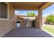 Covered patio area has a built in BBQ and fridge for the perfect outdoor kitchen at 12473 W Montgomery Rd, Peoria, AZ 85383