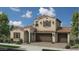 Charming two-story home featuring a tile roof, three-car garage, and manicured landscaping at 13159 N 153Rd Ave, Surprise, AZ 85379