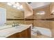 Bathroom with beige tile, dark wood vanity, large mirror, and tiled backsplash at 1316 N Spring Cir, Mesa, AZ 85203