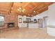 Open kitchen and living space featuring stainless appliances and a charming brick fireplace at 1316 N Spring Cir, Mesa, AZ 85203