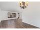 Bright living room with wood floors and a large window letting in plenty of natural light at 1316 N Spring Cir, Mesa, AZ 85203