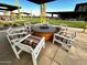 Outdoor firepit area features colorful seating and a shaded structure for community gatherings at 13226 E Verbina Ln, Florence, AZ 85132
