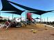 Community playground with modern play structures, shaded areas, and soft landing surfaces for safety at 13226 E Verbina Ln, Florence, AZ 85132