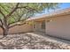 Low maintenance backyard featuring desert landscaping, block fence, and mature trees at 13337 W Evans Dr, Surprise, AZ 85379