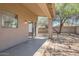 Backyard patio with a covered seating area, desert landscaping, and block fence at 13337 W Evans Dr, Surprise, AZ 85379