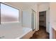 Bathroom featuring a soaking tub, shower, and linen closet at 13337 W Evans Dr, Surprise, AZ 85379