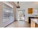 Eat-in kitchen featuring tile floor, sliding glass door to backyard, and a decorative chandelier at 13337 W Evans Dr, Surprise, AZ 85379